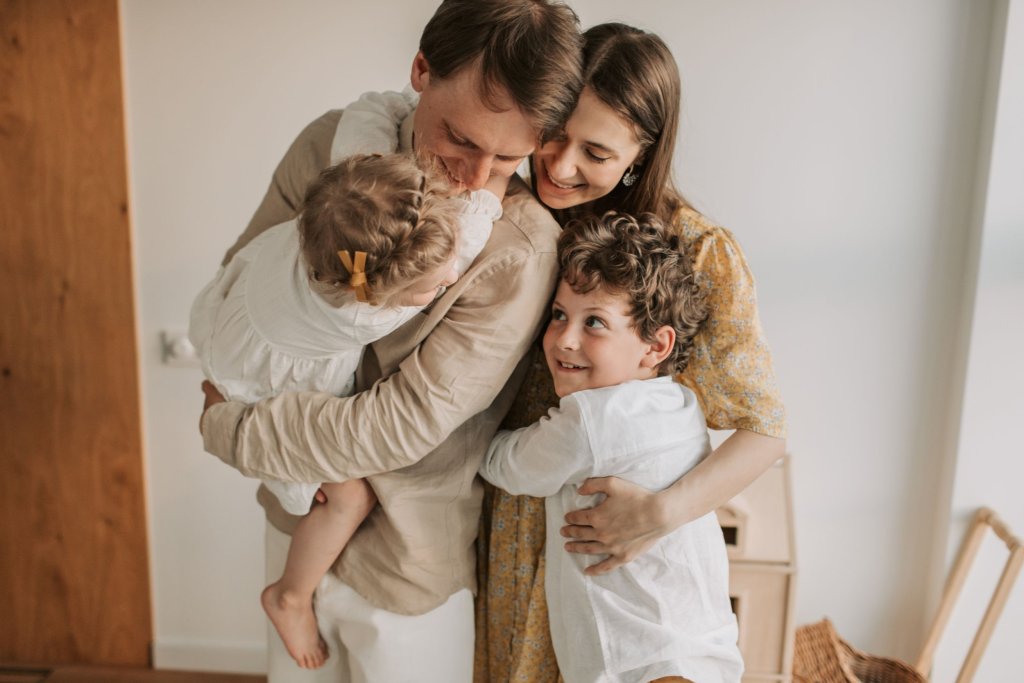 A family of four hugging