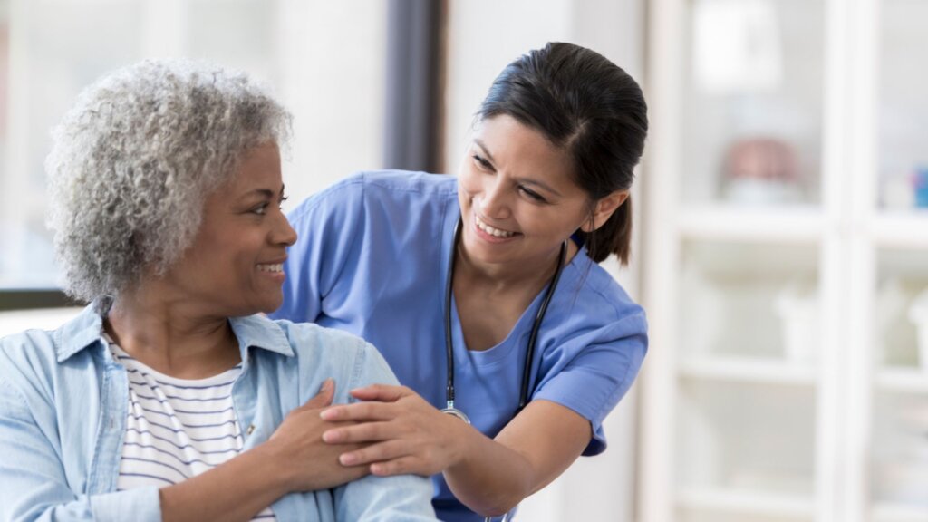 Happy Nurse Helping Patient 