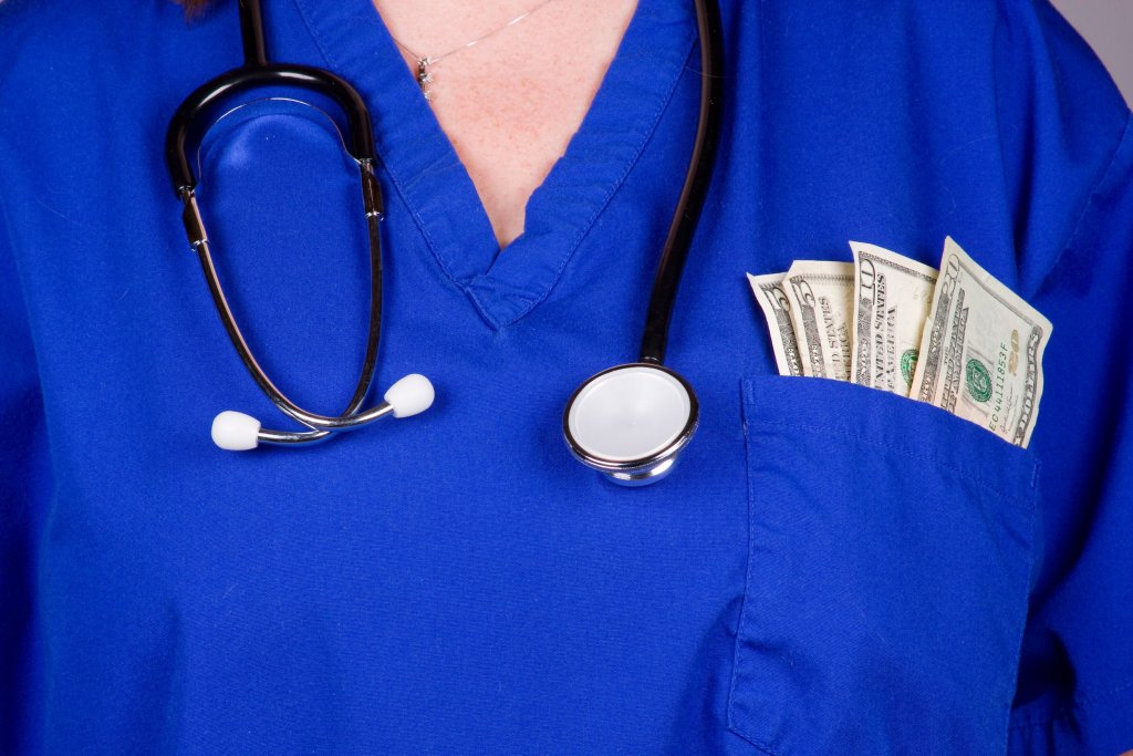 A nurse with cash in the pocket of her scrubs