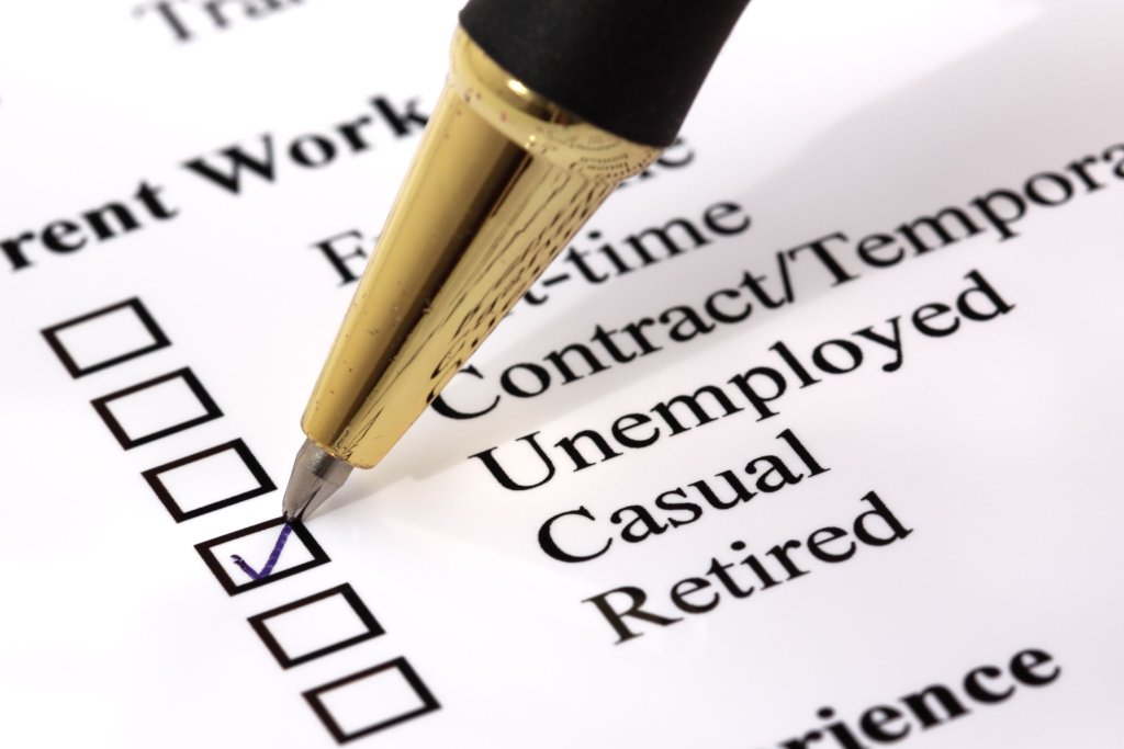 A person checking the unemployed box on a form