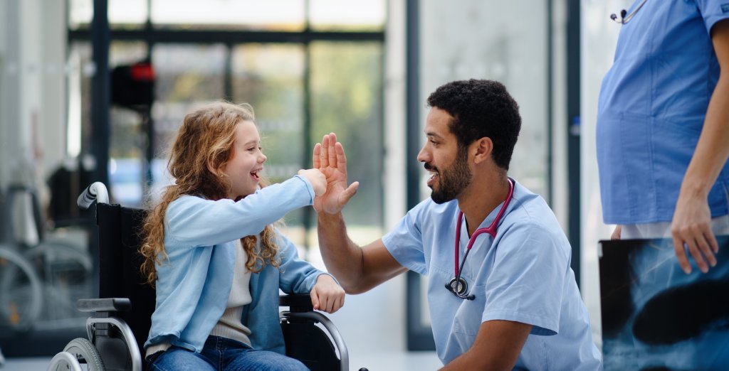 CNA giving child patient a fist bump