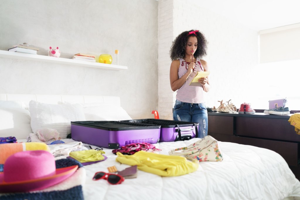 woman choosing what to pack for trip