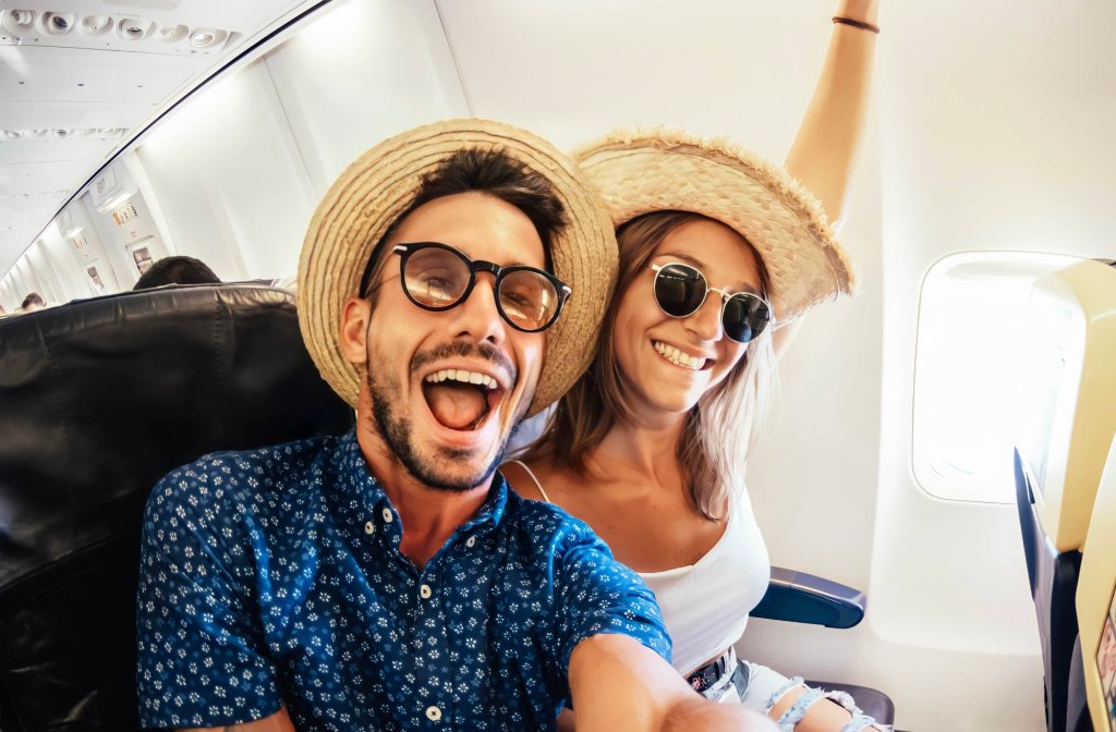 A happy couple takes a plane ride together. 