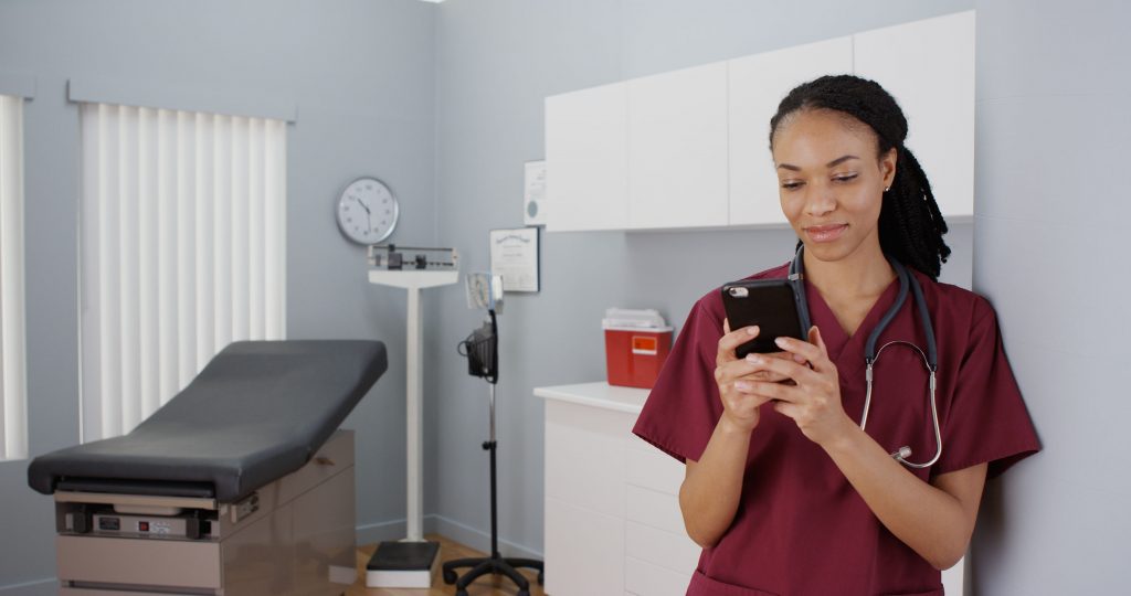 nurse using smart phone to manage patients