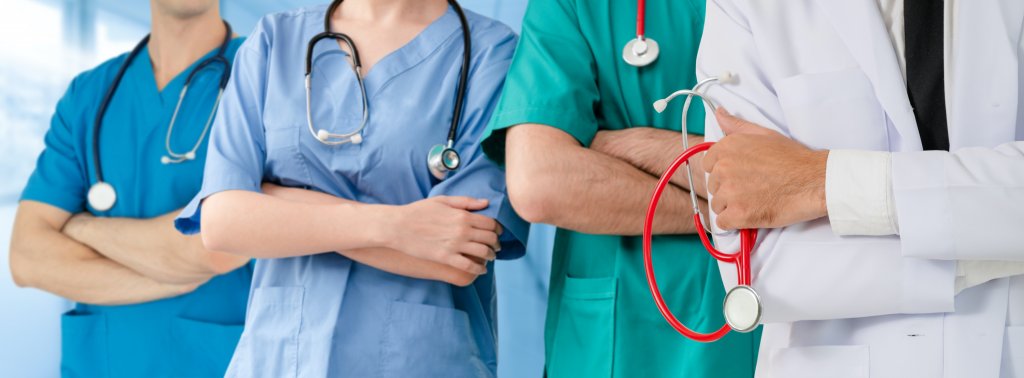 Staff nurses and travel nurses standing together in a hospital